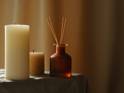Two candles and diffuser on the table 