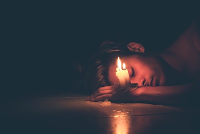 Man slipping beside lightened candles